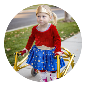 Girl wearing wonder woman costume walking with a walker